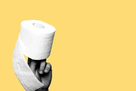 Concept of constipation, diarrhea, problem. Hand holding a toilet paper roll Stock Photos