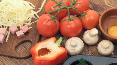 Concept of cooking egg muffins with ham, cheese and vegetables. Stock Footage 69939429