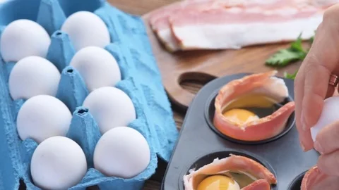 Concept of cooking eggs with bacon in muffin tin . Stock-Footage 69939115