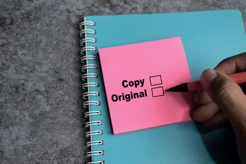 Concept of Copy or original write on sticky notes isolated on Wooden Table. Stock Photos