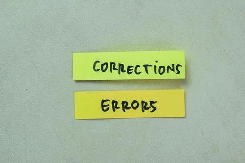 Concept of Corrections Errors write on sticky notes isolated on Wooden Table. Foto stock