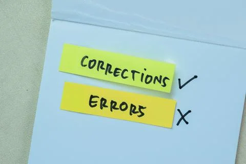 Concept of Corrections Errors write on sticky notes isolated on Wooden Table. 写真素材