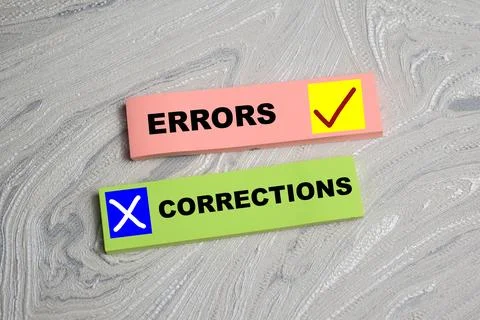 Concept of Corrections Errors write on sticky notes isolated on Wooden Table. Foto stock