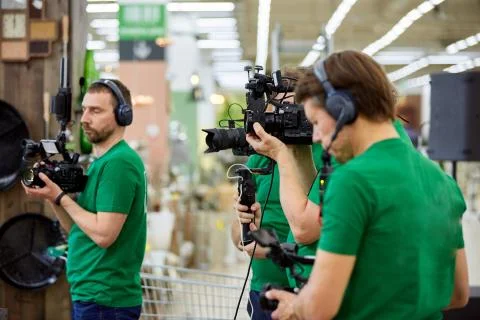 The concept of creating video content, a group of professional operators confer Stock Photos