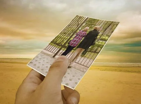  Concept creative collage with a hand holding a photo of a couple of matur... Fotos Stock