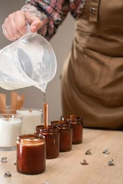 Concept of creative hobby and handmade candles. Close-up of female hands po.. Stock Photos