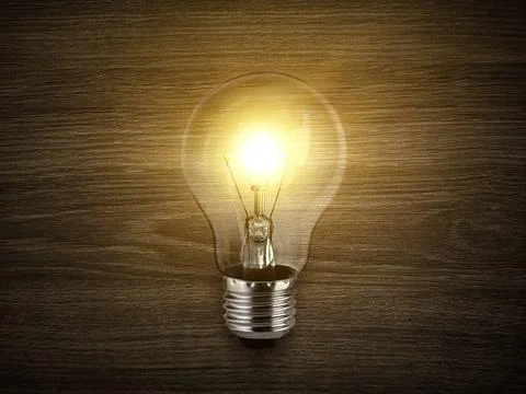 Concept creativity with bulbs that shine glitter on wood background Stock Photos