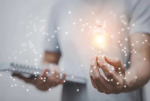 Concept creativity with light bulbs and energy power, Man hand holding light  Stock Photos
