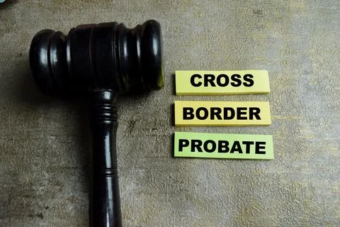Concept of cross border probate write on sticky notes and judge gavel Stock Photos