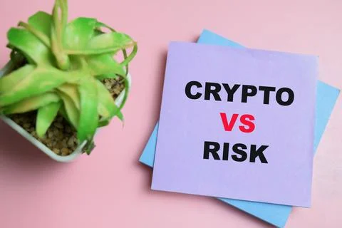 Concept of crypto vs risk write on sticky notes isolated on table. Stock Photos