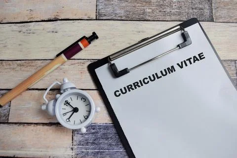 Concept of curriculum vitae write on clipboard isolated on Wooden Table. Stock Photos