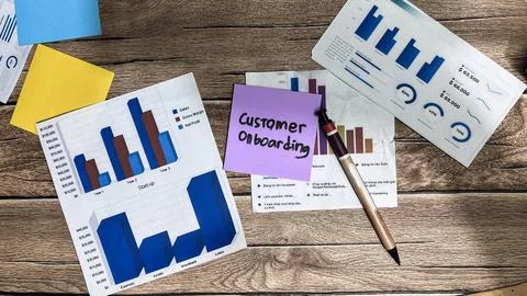 Concept of Customer Onboarding write on sticky notes isolated on Wooden Table Foto stock