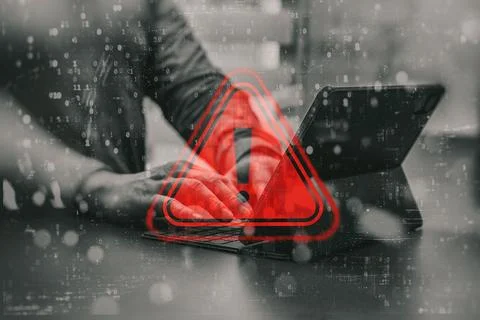 Concept cybersecurity alert. A hacker is working with a laptop. Red alert s.. 写真素材