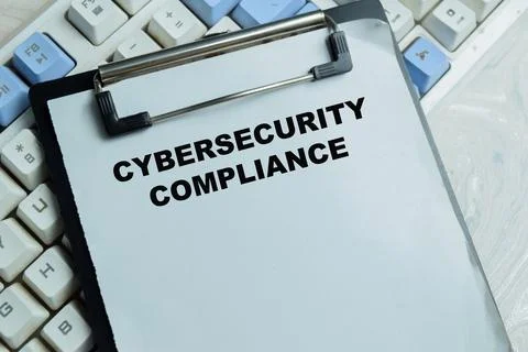 Concept of cybersecurity compliance write on clipboard Stock Photos