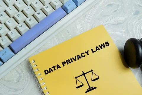 Concept of data privacy laws write on book isolated on Wooden Table. Stock Photos