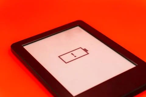 Concept A dead battery on a modern device, a device without a charger on a red Stock Photos