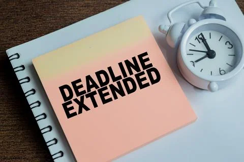Concept of deadline extended write on sticky notes isolated on Wooden Table. 스톡 사진