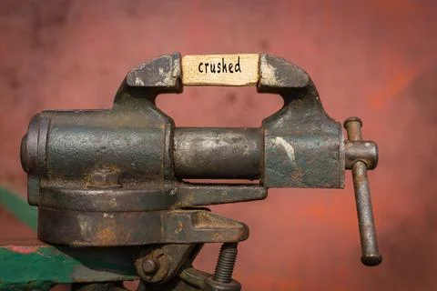 Concept of dealing with problem. Vice grip tool squeezing a plank with the wo Stock Photos