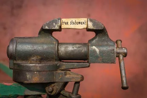 Concept of dealing with problem. Vice grip tool squeezing a plank with the wo Foto stock