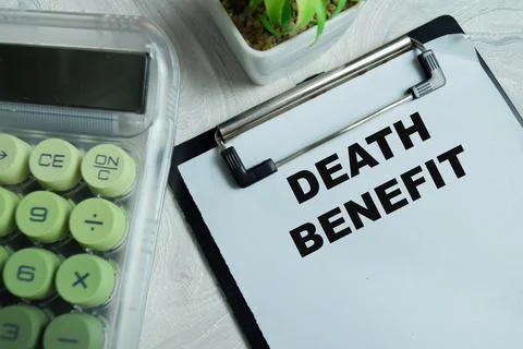 Concept of death benefit write on clipboard isolated on Wooden Table. 스톡 사진