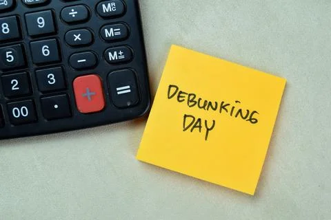 Concept of Debunking Day write on sticky notes isolated on Wooden Table. 스톡 사진