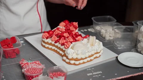 Concept of decoration of Christmas cake in shape of Santa Claus boot Stock Footage 166529383