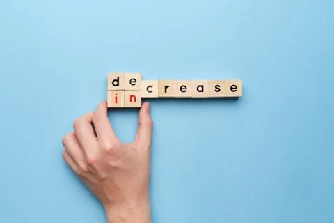 Concept of decrease and increase on wooden cubes Stock Photos