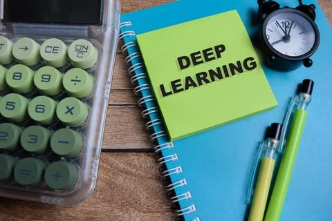 Concept of deep learning write on sticky notes isolated on Wooden Table. Stockfoto's