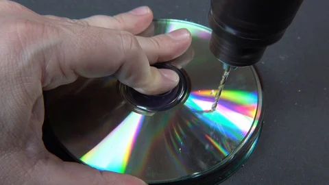 Concept of deleting big data by drilling a hole into the DVD RAM Stock Footage 107832774
