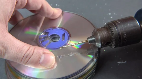 Concept of deleting big data by drilling a hole into the DVD RAM Stock Footage 107874322