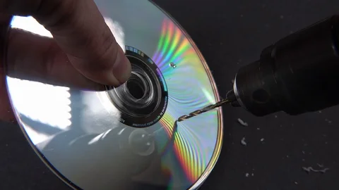 Concept of deleting big data by drilling a hole into the DVD RAM Stock Footage 107875382