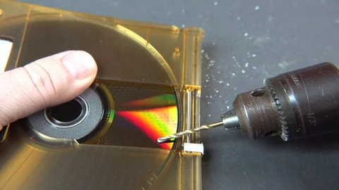 Concept of deleting big data by drilling a hole into the DVD RAM Stock Footage 107905789