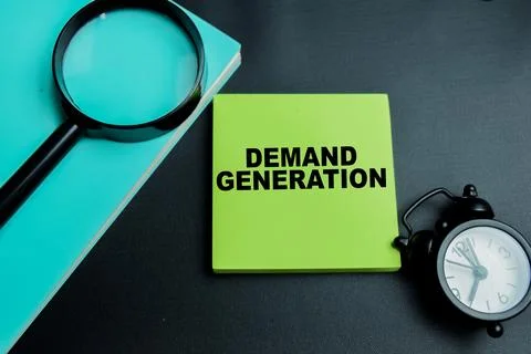 Concept of demand generation write on sticky notes isolated on table. Stock Photos