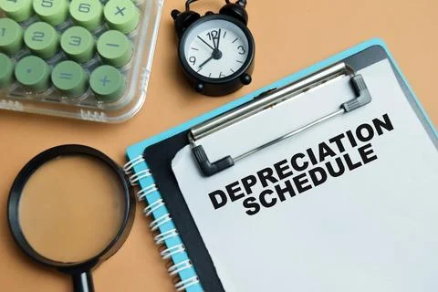 Concept of depreciation schedule write on clipboard isolated on table. Stock Photos