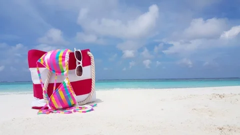 Concept design with summer set bag, bikini and sunglasses left on white Stock Footage 120273397