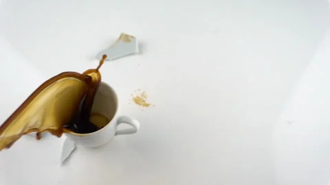 The concept of destruction with copy space. Falling and breaking cup of coffe in Stock Footage 116396760