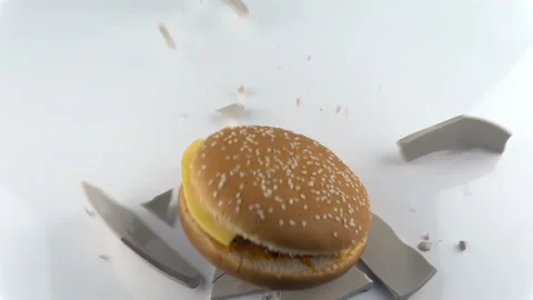 The concept of destruction. Falling and breaking plate with hamburger in slow mo Stock Footage 116396688