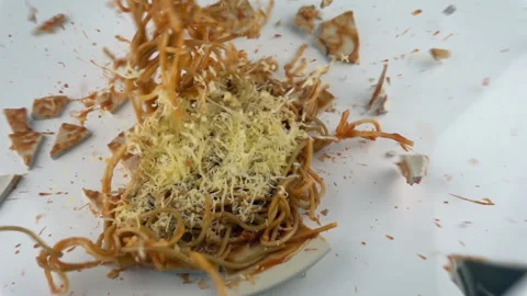 The concept of destruction. Falling and breaking plate with pasta in slow motion Stock Footage 116396723
