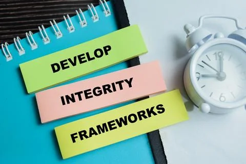 Concept of develop integrity frameworks write on sticky notes Stock Photos