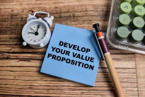 Concept of develop your value proposition write on sticky notes Stock Photos
