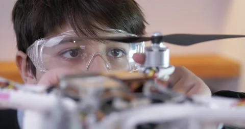 The concept of developing technical skills in a child. A boy in goggles looks Stock Footage 147453490