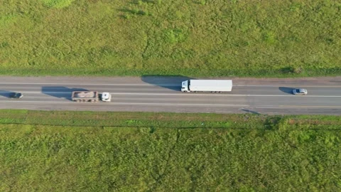 Concept of development of international road transport. White truck on the road Stock Footage 157574403