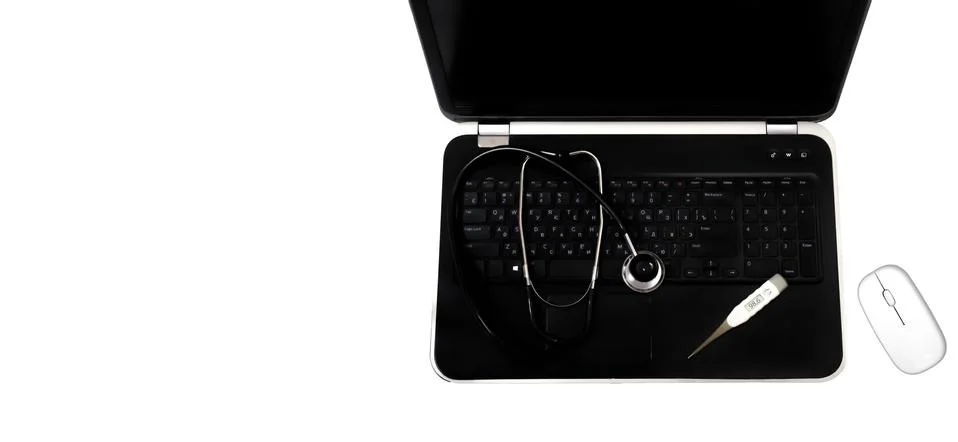 Concept: diagnostics, laptop and computer repair. A silver stethoscope lying Stock Photos