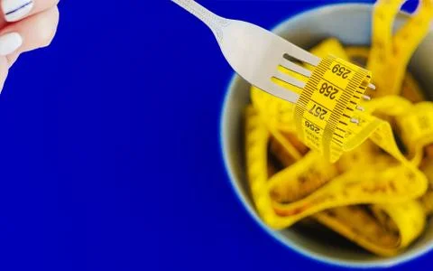 The concept of the diet. The fork rewound centimeter lying on plate closeup Stock Photos