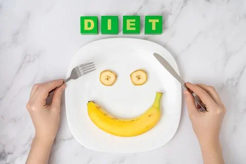 The concept of a diet with pleasure. Female hands with a fork and a table kni Stock Photos