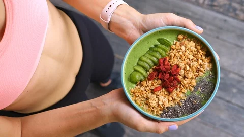 Concept Of Diet, Proper Nutrition And Health. Sport Woman Holding Smoothie Bowl Stock Footage 90950145