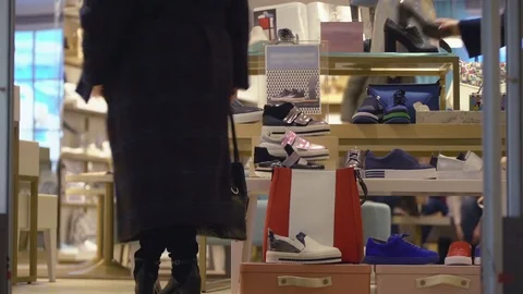Concept of difficult choice process.. Women on shopping in a shoe store on the Stock-Footage 80221401
