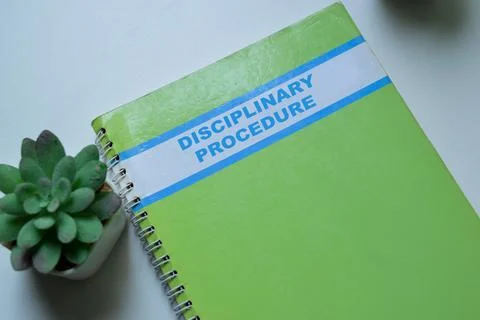 Concept of Disciplinary Procedure write on book isolated on Wooden Table. Stock Photos