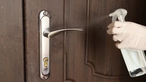 The concept of disinfecting surfaces from bacteria or viruses, cleaning the door Stock Footage