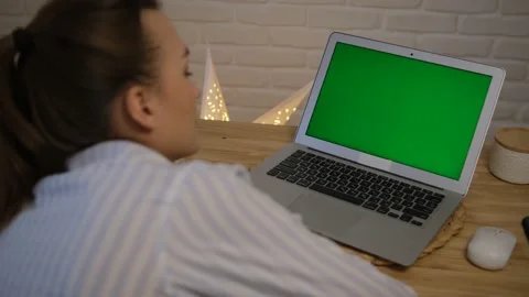 The concept of distance learning, work. Green computer screen. The girl sits at  Stock Footage 148523523